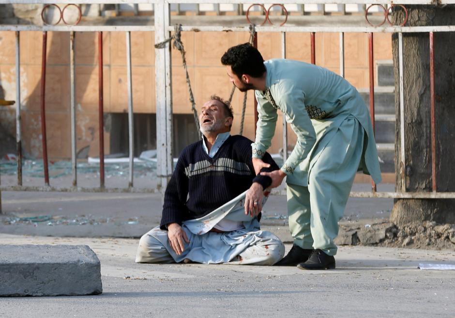 Man reacts after hearing his son was killed during a car bomb attack in Kabul